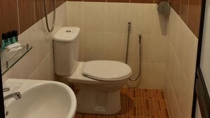 A bathroom with a toilet, bidet, and sink. - Grandview VIP Home (Gali)