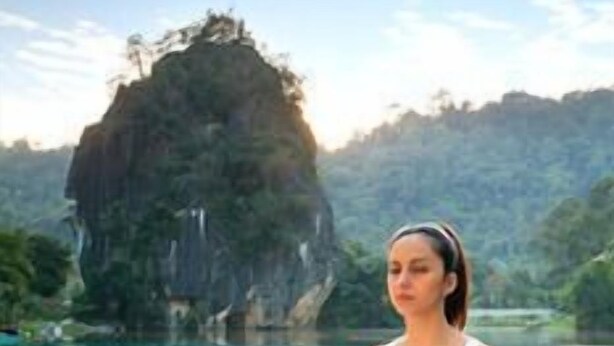 A person meditating by a pool with a mountainous backdrop. - TUI Blue The Haven Ipoh (Ipoh)