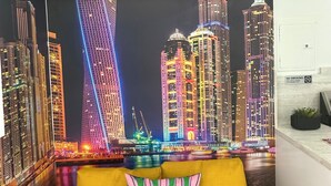 A living room with a vibrant cityscape mural on the wall, a yellow sofa, and a "No Smoking" sign. - Charming 1-bedroom apartment with AC, WiFi in vibrant Miami (Miami)