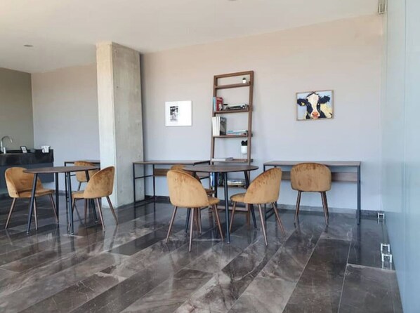 Relax and work in style with a central table and bookshelf.