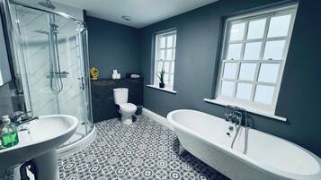 A bathroom with a shower, toilet, sink, and bathtub.