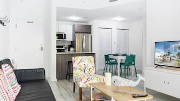 Apartment, City View | Living area | 50-inch Smart TV with cable channels