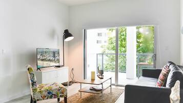 Apartment, City View | Living area | 50-inch Smart TV with cable channels