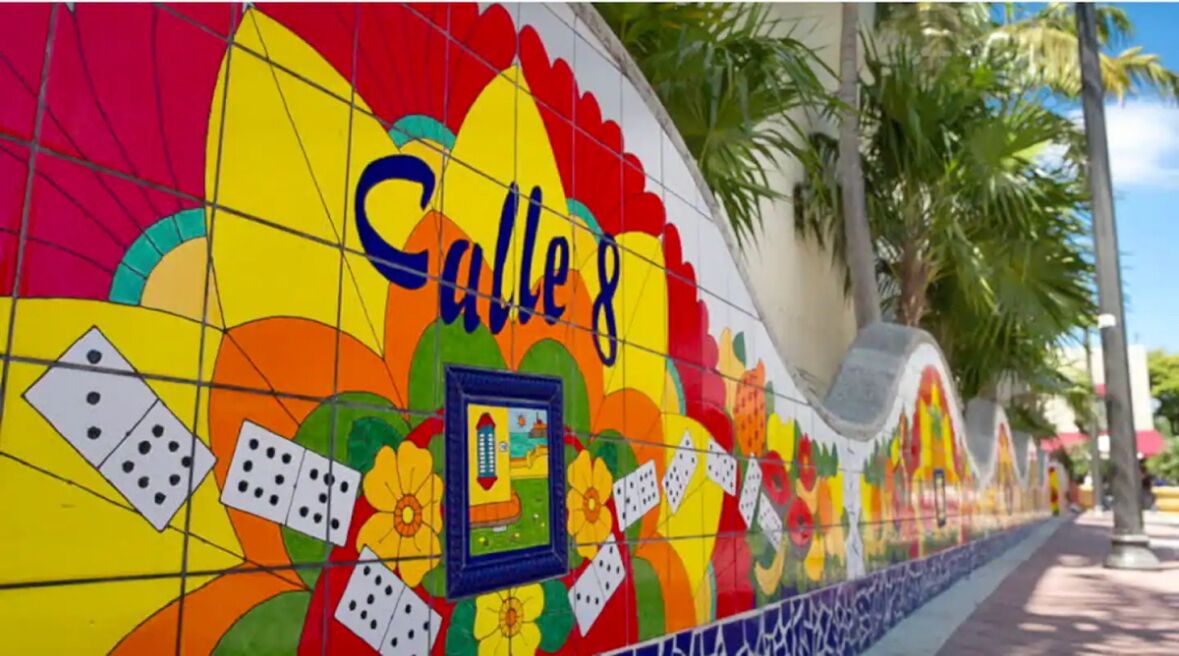A colorful tiled wall with the text "Calle 8" and a framed picture.
