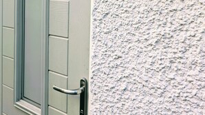 A door with a window and a metal handle, and a textured wall with a plaque that reads "Ty Hiraeth". - Ty Hiraeth 

A Charming Stay Steps Away from Caerphilly Castle!
 (Caerphilly)
