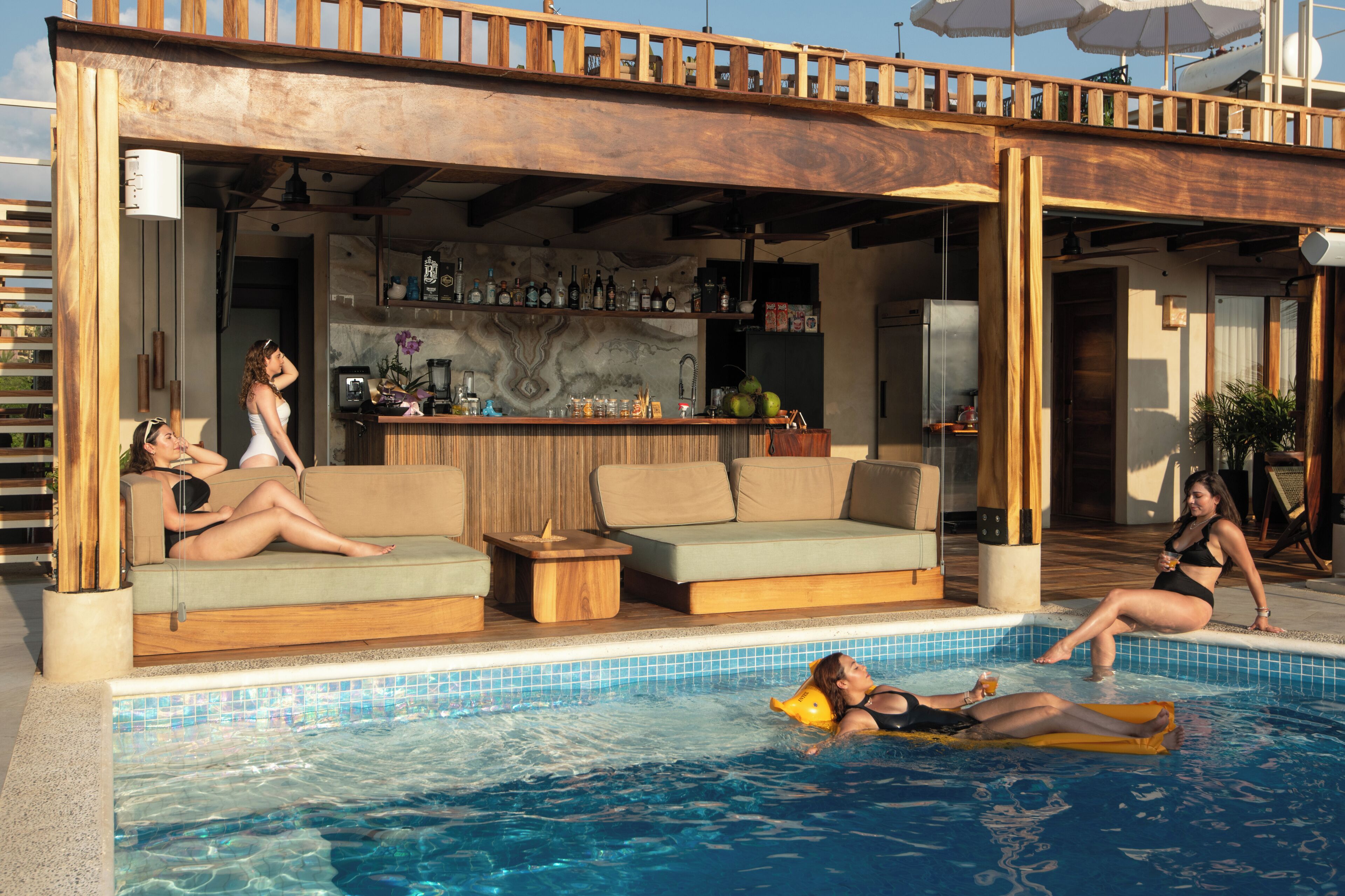 A poolside area with a bar, seating, and a view of the pool.