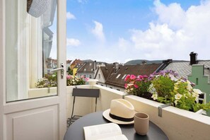 Enjoy a peaceful view of the surrounding residential area from this balcony.