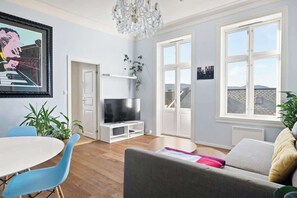 Relax in this stylish living room with a city view, flat-screen TV, and comfortable seating area.