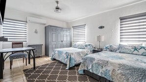 A bedroom with two beds, a desk, a chair, and a wardrobe. - Cozy 2-bedroom apartment with AC, WiFi in charming Cabo San Lucas (Cabo San Lucas)