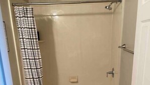A small bathroom with a toilet, a shower with a glass door, and a bathtub. - Clean, quiet, centrally located home (Salt Lake City)