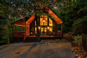 A log cabin with a porch, a staircase, and a balcony. - Peaceful private, King Bed, hot tub, arcade, minutes to attractions and parkway (Sevierville)
