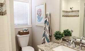 A bathroom with a toilet, a sink with a mirror, a window with blinds, and a towel rack. - Designer decorated 6 bedroom pool house (Santa Ana)
