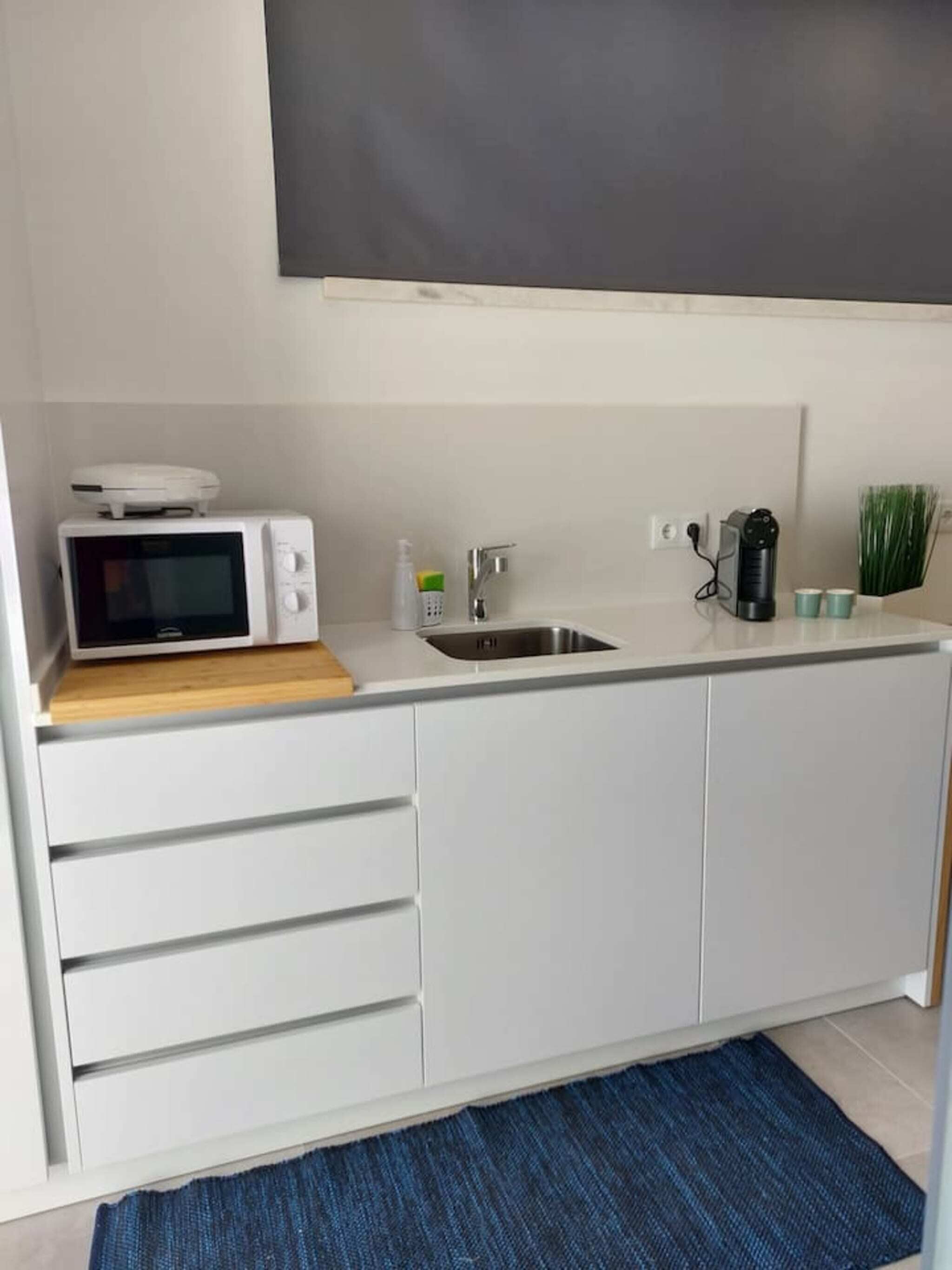 Coffee/tea maker, fridge, microwave, cookware/dishes/utensils