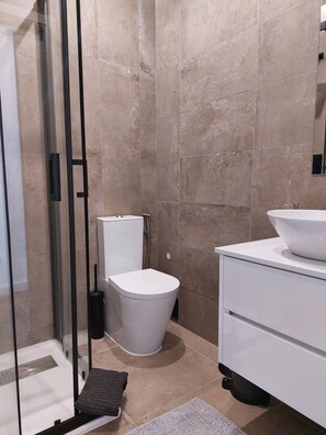 Shower, hair dryer, towels, toilet paper