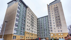 A high-rise residential building with multiple floors, large windows, and a brick facade. - Student Only Buchanan View (Glasgow)