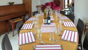 A dining table set for a meal with wine glasses, plates, and cutlery. - 5 bedroom accommodation in Horton, near Gower (Horton, near Gower)