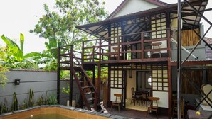 A traditional Japanese-style house with a wooden deck and a small pool. - Griya De Sachi (Cepaka)