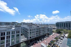 A multi-story building with a parking lot in front.