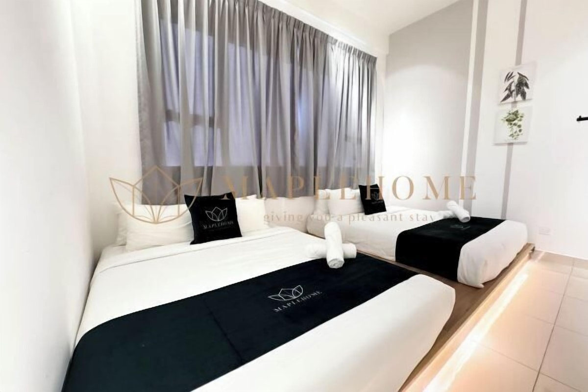 A hotel room with two beds, a large window with sheer curtains, and a wall-mounted artwork.
