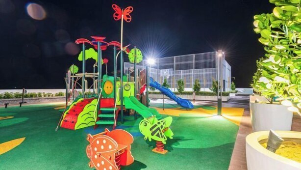 A playground with slides and climbing structures at night. - Amber Cove Premier Suites Melaka (Melaka)
