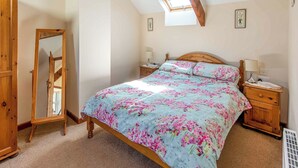 A bedroom with a bed, wooden wardrobe, and a skylight. - The Old Shippen - UK48328 (Lifton)