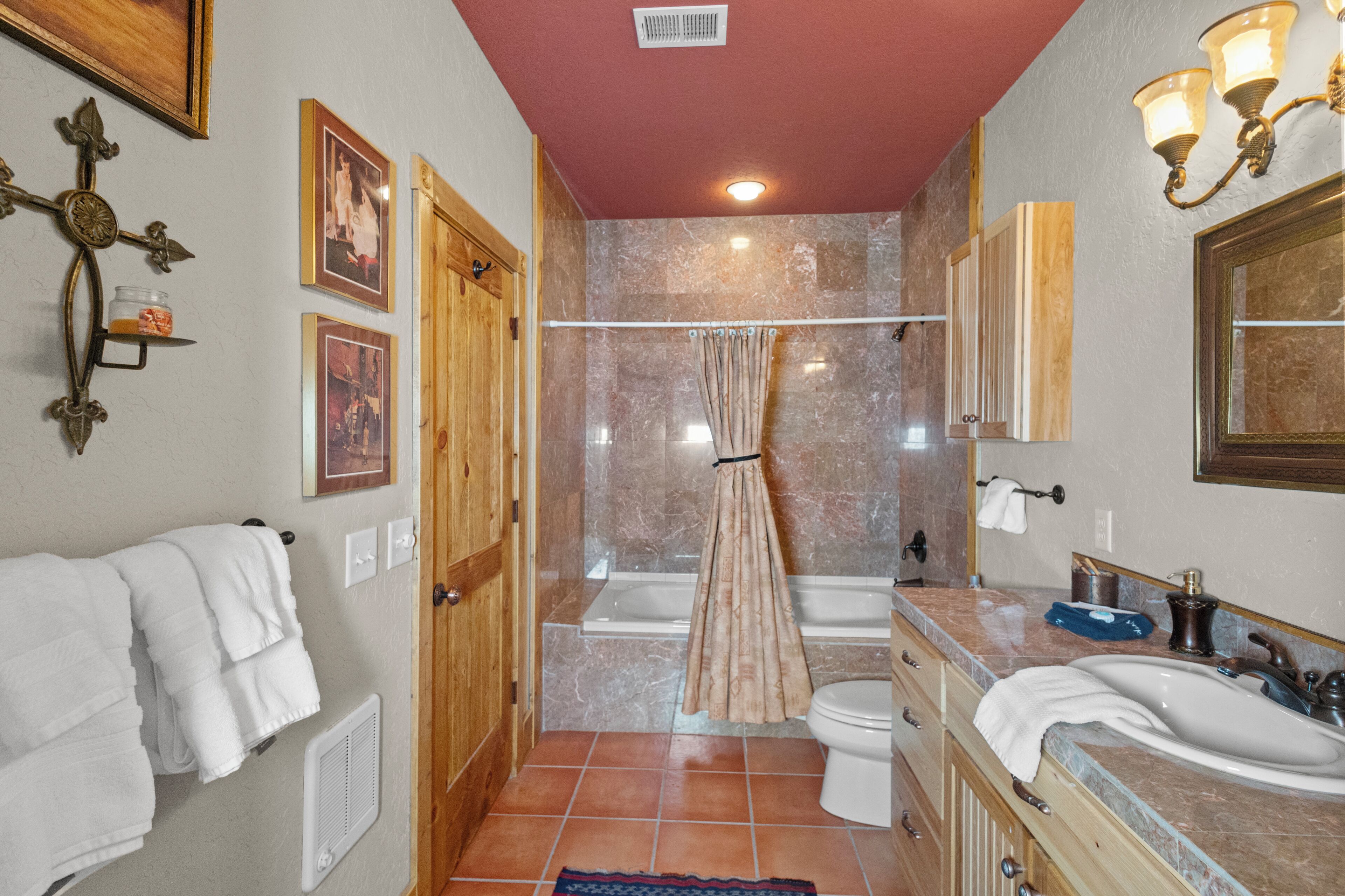 A bathroom with a bathtub, toilet, and sink.