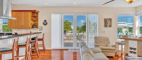 Un amplio salón con cocina, comedor y balcón con vistas.