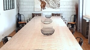 A conference room with a long table, chairs, and a large wall-mounted painting. - Chalet "Sublime Chalet 14 Pers Spa Extrieur" with Mountain View (Cauterets)