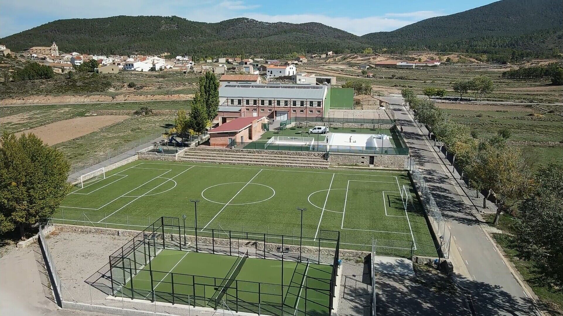 A sports field with a building in the background.