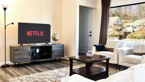 A living room with a TV, a globe, a coffee table, and a sofa. - Entire house 3BR, Pets, kitchen, Parking, Laundry, Large Fenced backyard, WiFi (Kitchener)