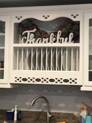 A kitchen with a white cabinet displaying the word 'Thankful' and a decorative garland above it. - 3-bedroom house in East Whittier with AC/heating for a relaxing stay any season! (Whittier)
