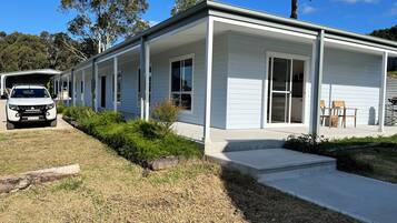 Enjoy outdoor dining or relaxation on the covered porch with comfortable seating.