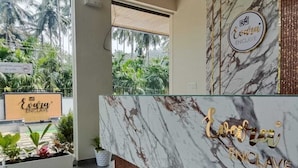 A reception desk with a marble surface and a sign that reads "Evita ENCLAVE." - Evara Enclave Residency (Sullia)