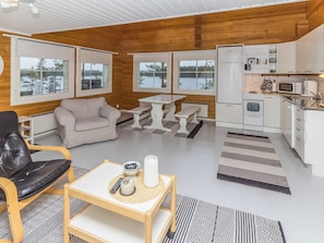 A cozy cabin interior with a living area, dining space, and kitchen. - Onnimanni by Interhome (Kuusamo)
