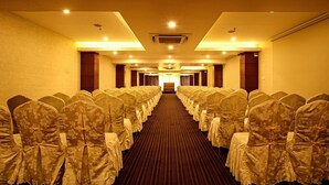 A hotel room with a long, carpeted hallway leading to a door at the end. - The Atrium Boutique Hotel (Mysore)