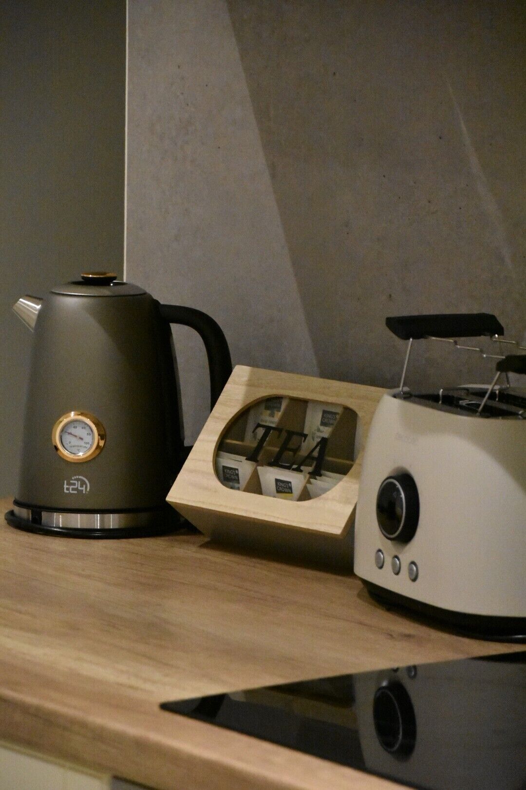 A kitchen counter with a coffee maker, a tea infuser, and a toaster.