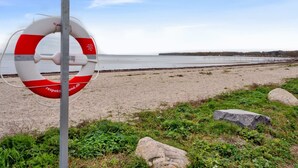A lifebuoy on a pole by a beach with a clear sky. - "Lio" - 200m from the sea by Interhome (Bjert)