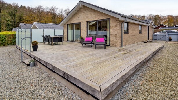 A modern house with a wooden deck, a glass conservatory, and a garage. - "Lio" - 200m from the sea by Interhome (Bjert)