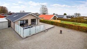 A modern house with a balcony, a gravel driveway, and a view of the sea. - "Lio" - 200m from the sea by Interhome (Bjert)