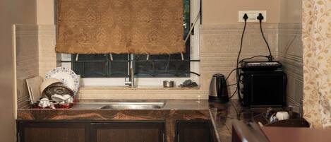 A compact kitchen with a sink, a toaster, and a refrigerator.