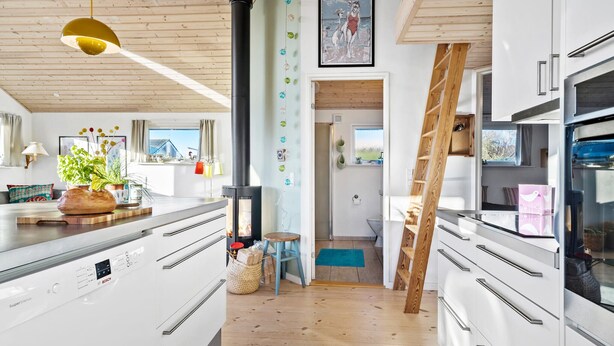 A modern kitchen with white cabinets, a Bosch refrigerator, and a wooden ceiling. - Stunning home in Haderslev with WiFi (Haderslev)