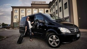 A black van parked in front of a building with a sign that reads "HOTEL DISAVAI DEPA." - Hotel PisaValdera (Pontedera)