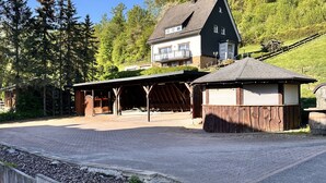 A two-story house with a large garage and a covered outdoor area.