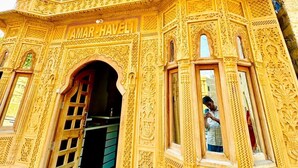 A building with intricate carvings and the name "AMAR-HAVELI" visible on the entrance. - Hotel Amar Haveli (Jaisalmer)