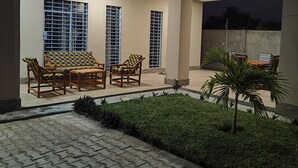 Un patio al aire libre con una zona de estar, un pequeño jardín y un tragaluz.