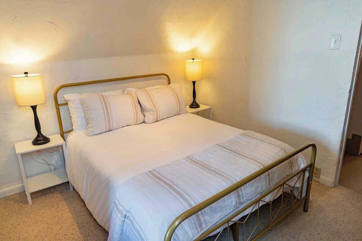 Full bedroom is cozy and has a closet, dresser, and ensuite laundry and bath