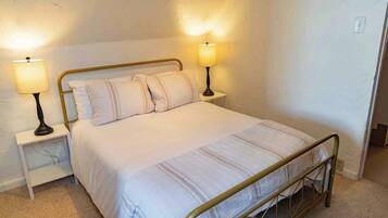 Full bedroom is cozy and has a closet, dresser, and ensuite laundry and bath