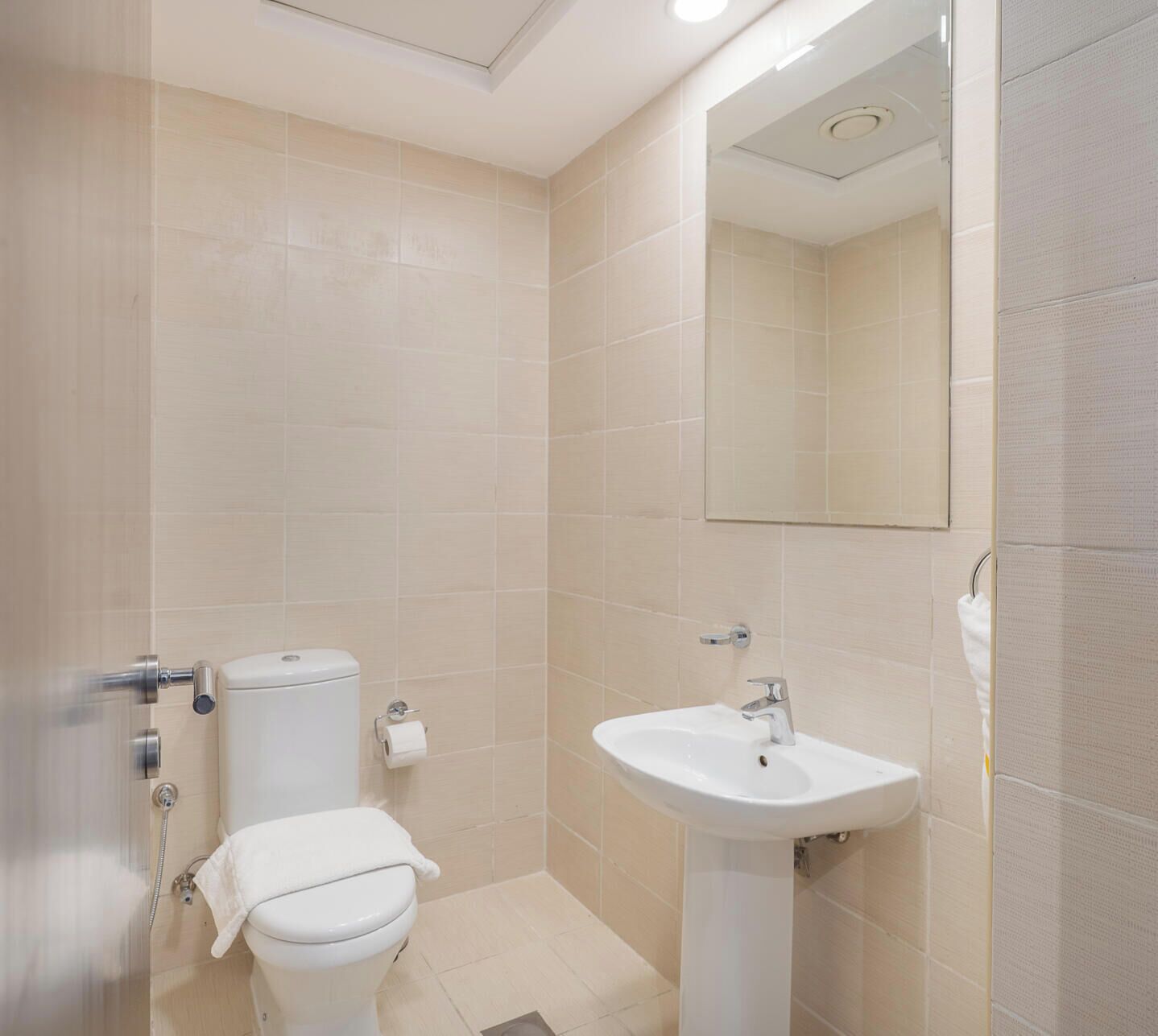 A bathroom with a toilet, sink, and shower.