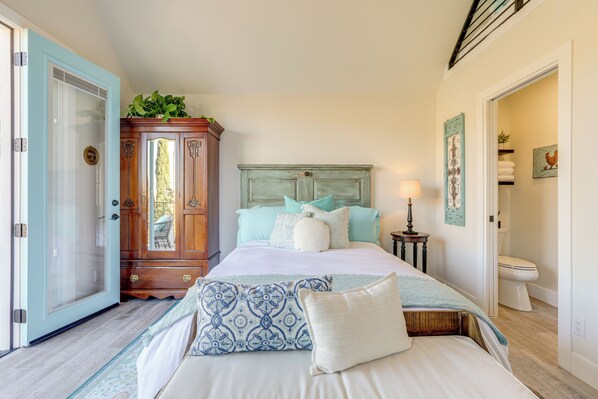 A bedroom with a bed, a wardrobe, a bedside table, and a toilet.