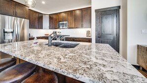 A modern kitchen with granite countertops, stainless steel appliances, and wooden cabinets. - 8 Mi to Keystone Resort: Mtn-view Townhome (Silverthorne)